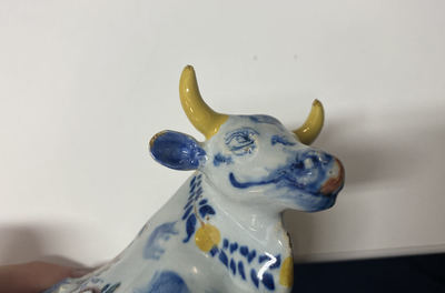 A polychrome Dutch Delft butter tub and cow cover, 18th C.